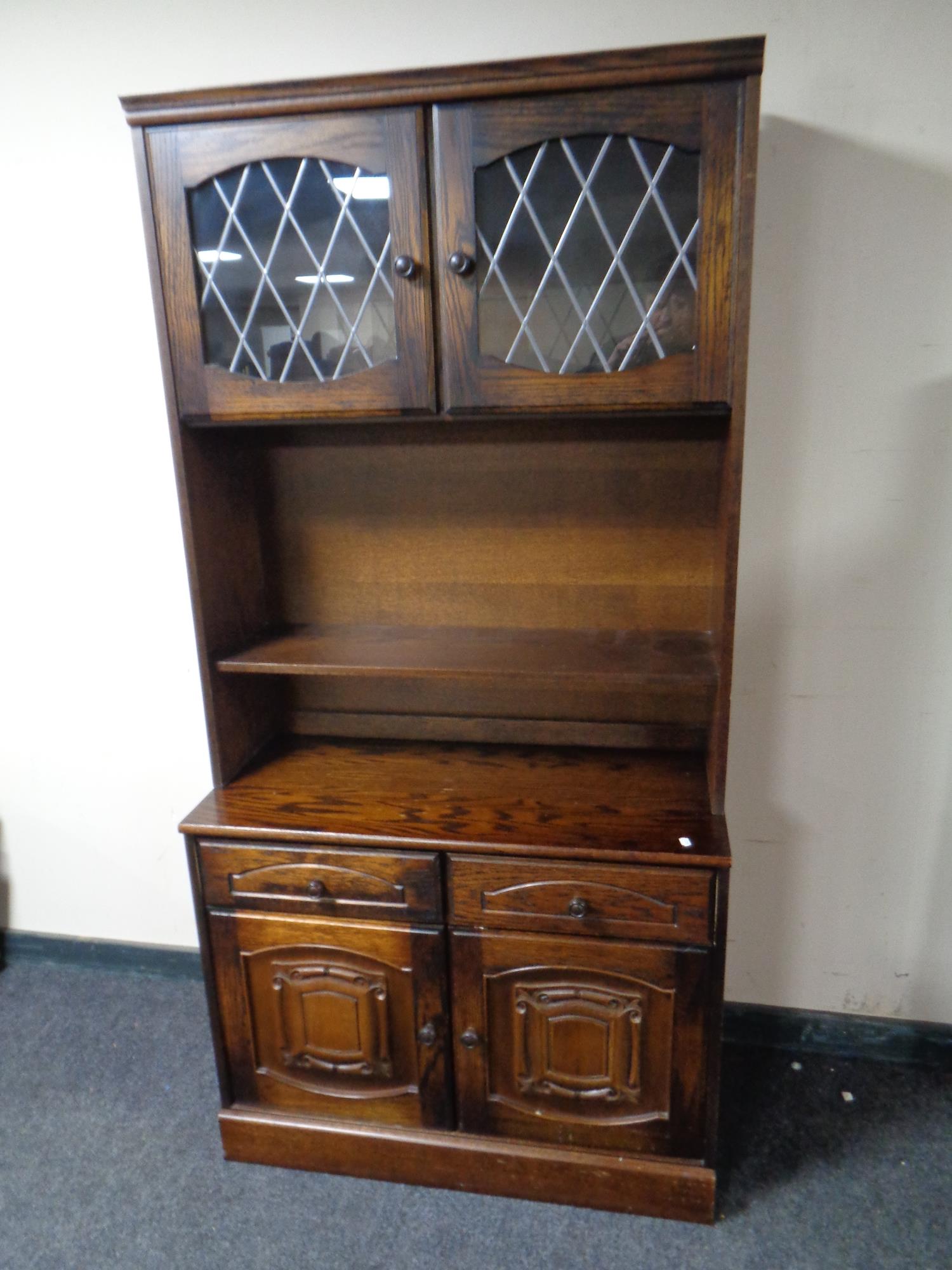 A display cabinet fitted double door cupboard and drawers beneath in an oak finish together with a