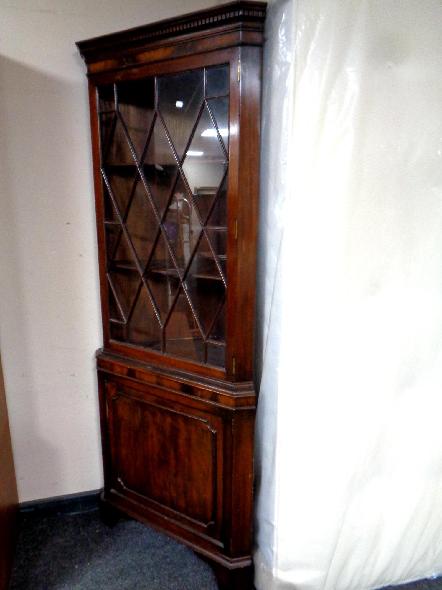 A mahogany glazed door corner display cabinet fitted cupboard beneath together with an inlaid