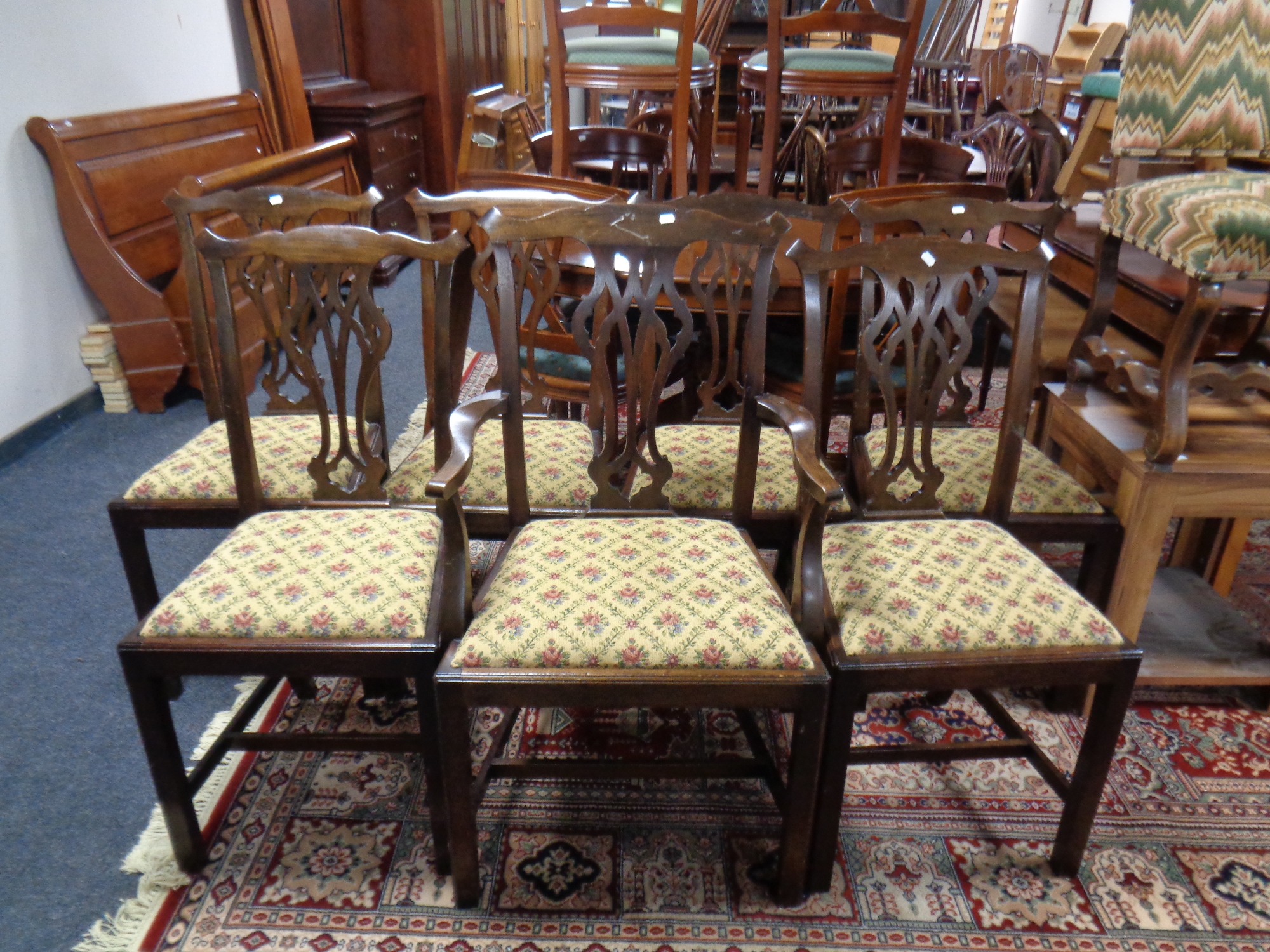 A set of seven antique Hepplewhite style dining chairs comprising of one carver,