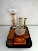 A tray containing two pairs of antique brass candlesticks,