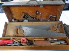A vintage wooden joiner's toolbox containing a large quantity of hand tools to include saws,