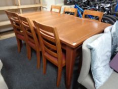 A Marks & Spencers Home extending dining table together with a set of six ladder back chairs