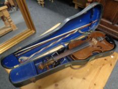 A 20th century violin with two bows in a hard shell case