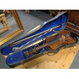 A 20th century violin with two bows in a hard shell case