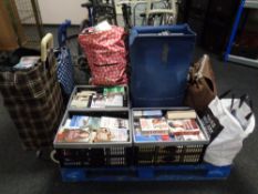 Five shopping trolleys and three crates containing a large quantity of hardback and paperback