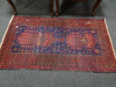 A fringed Afghan rug