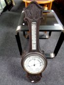 An Edwardian carved oak banjo barometer