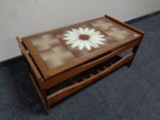 A 20th century teak tile topped coffee table with undershelf