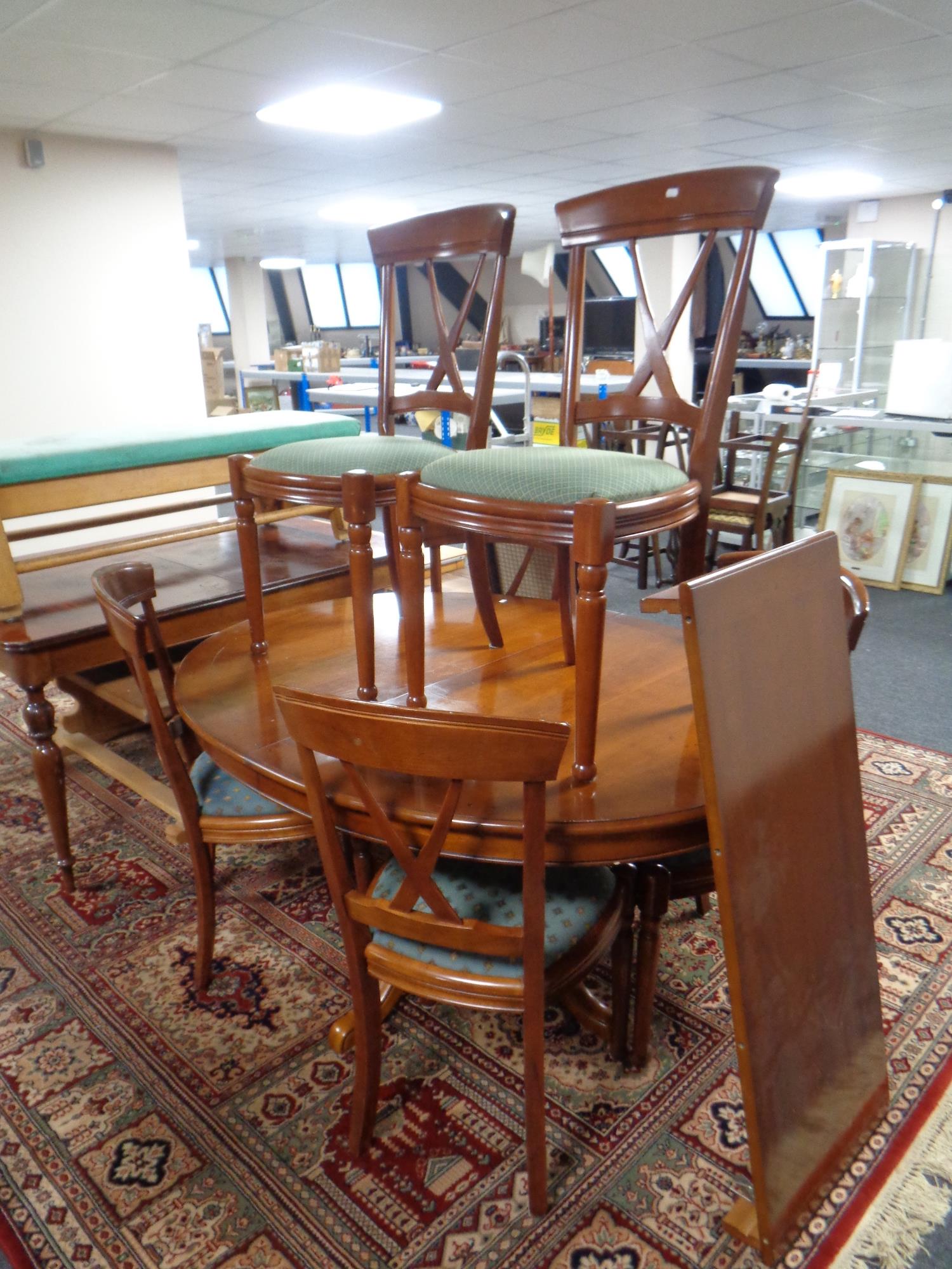 A good quality reproduction oval pedestal extending dining table with leaf together with a set of