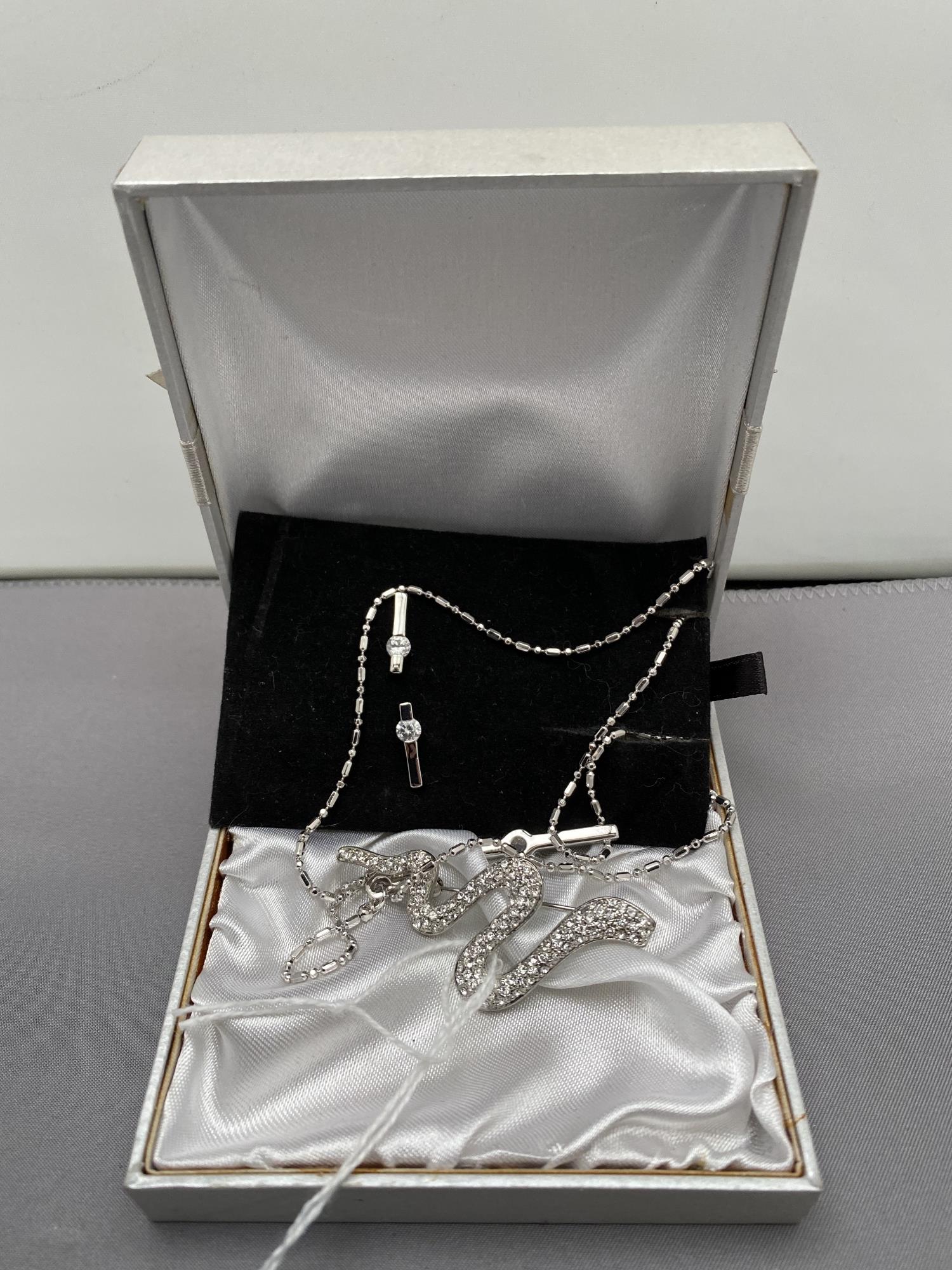 A pendant and earrings set in box together with a snake brooch