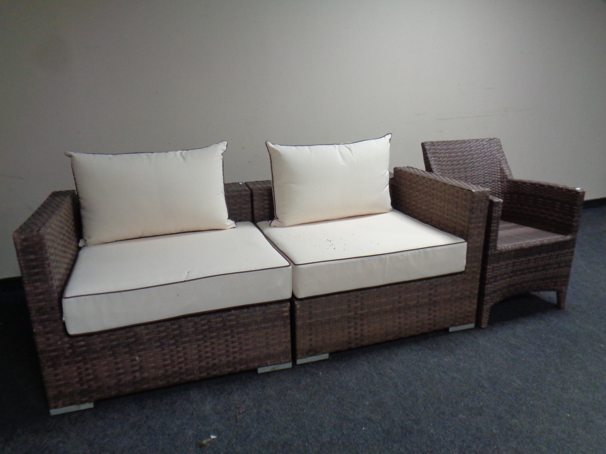 A rattan two seater settee together with an armchair