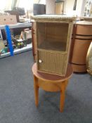 A gold glass topped Lloyd Loom bedside cabinet together with a two tier circular occasional table