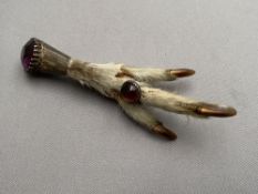 A claw brooch with inset amethyst