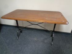 A 20th century refectory pub table on cast iron base