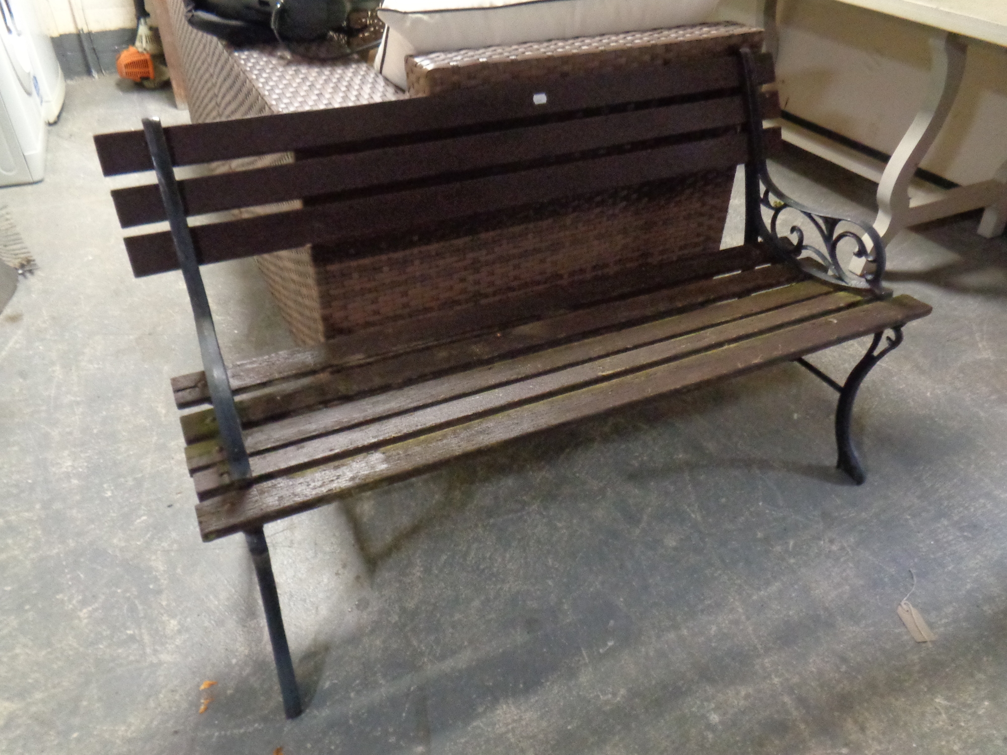 A wooden slatted cast iron-ended garden bench