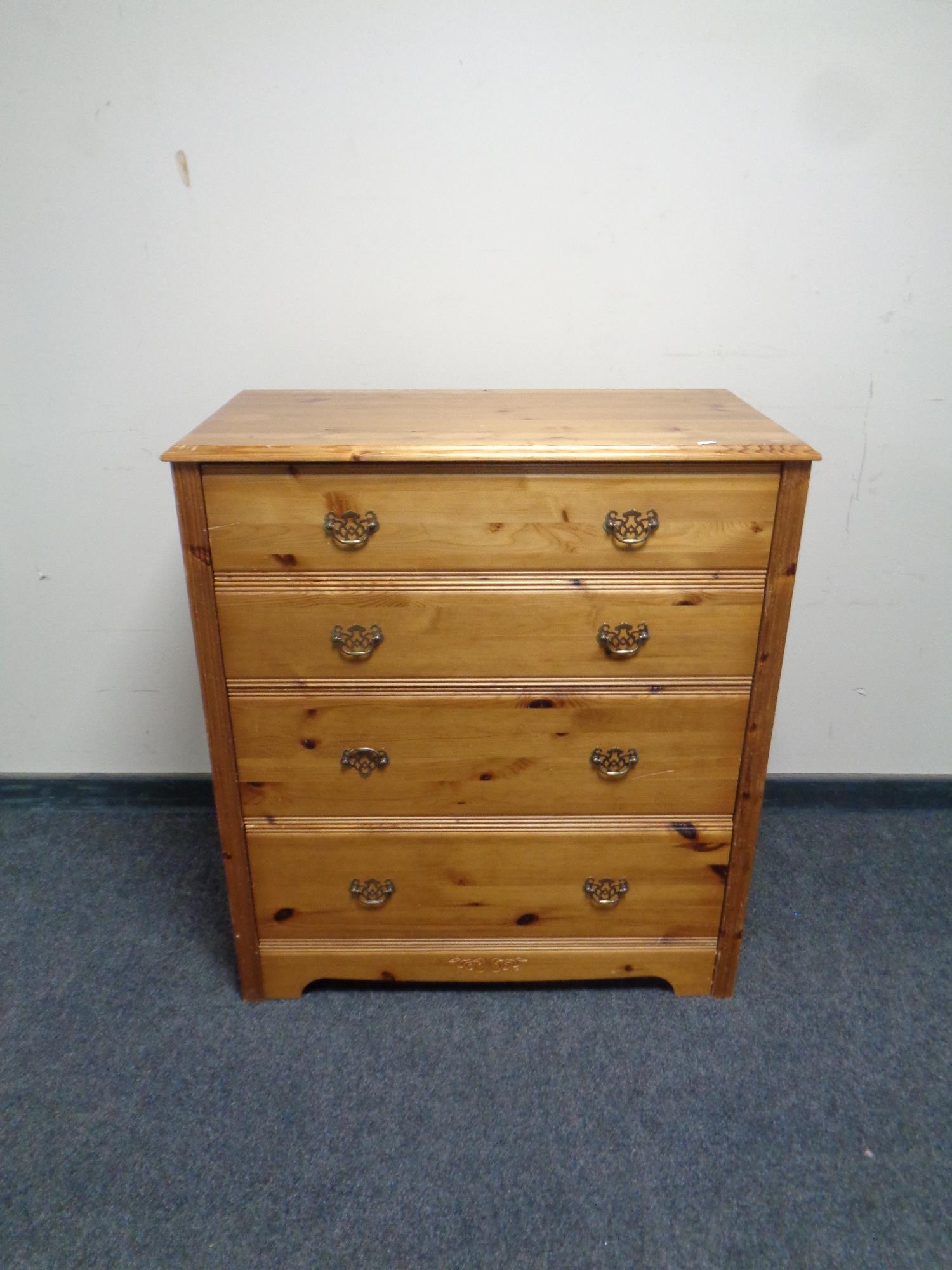 A contemporary pine four drawer chest