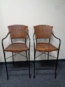 A pair of contemporary metal and wicker breakfast bar chairs