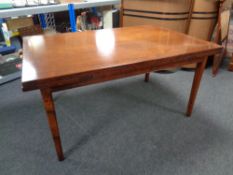 A contemporary extending dining table in a mahogany finish