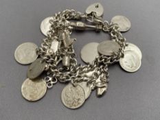 A silver bracelet with charms CONDITION REPORT: 61g