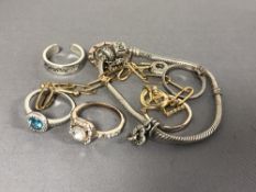 A small quantity of dress rings (6), gold plated chain and charm bracelet.