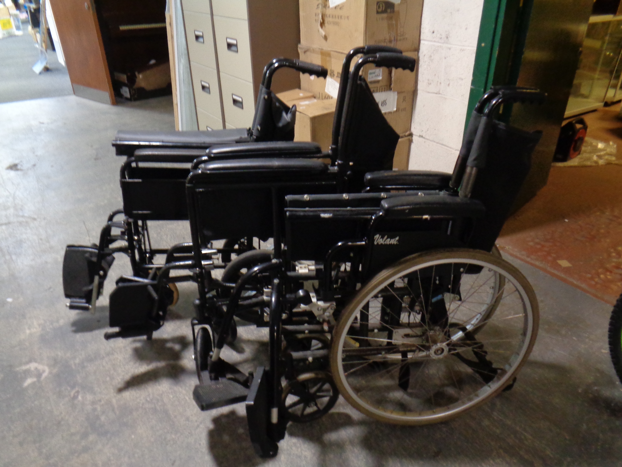 Three folding wheelchairs