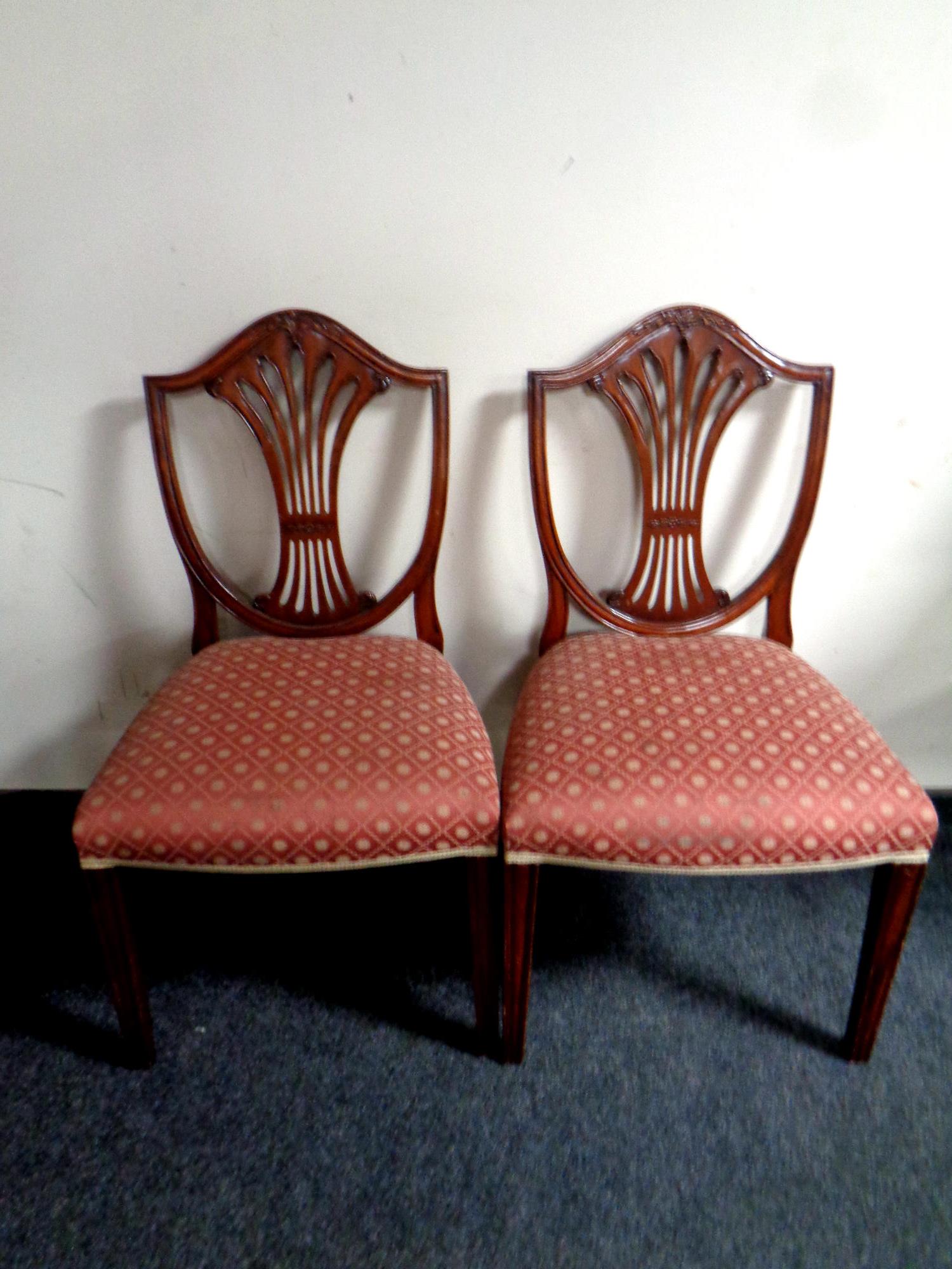 A pair of mahogany shield back dining chairs