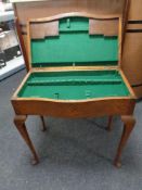 An Edwardian oak cutlery table on Queen Anne legs