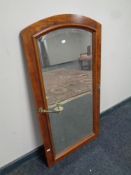 An antique dome topped bevel edged mirror with brass candle sconces