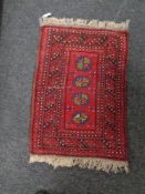 A fringed Persian hearth rug