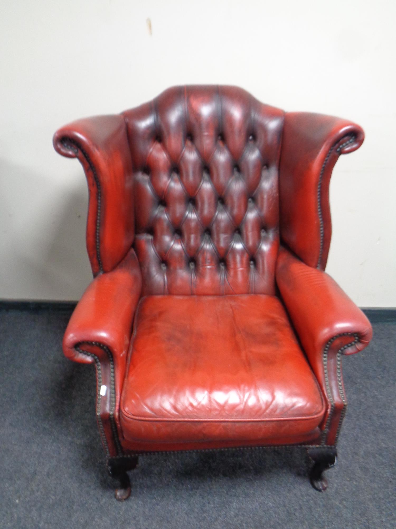 A Chesterfield red button leather wingback armchair