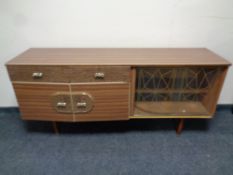 A mid 20th century teak melamine low sideboard