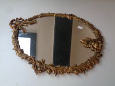 A decorative gilt metal framed mirror together with two cut glass lidded trinket pots and two cut