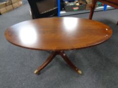 An inlaid mahogany oval pedestal coffee table