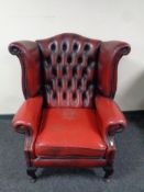 A Chesterfield red button leather wingback armchair