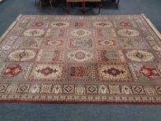 A Zenith fringed Persian style carpet of geometric design,