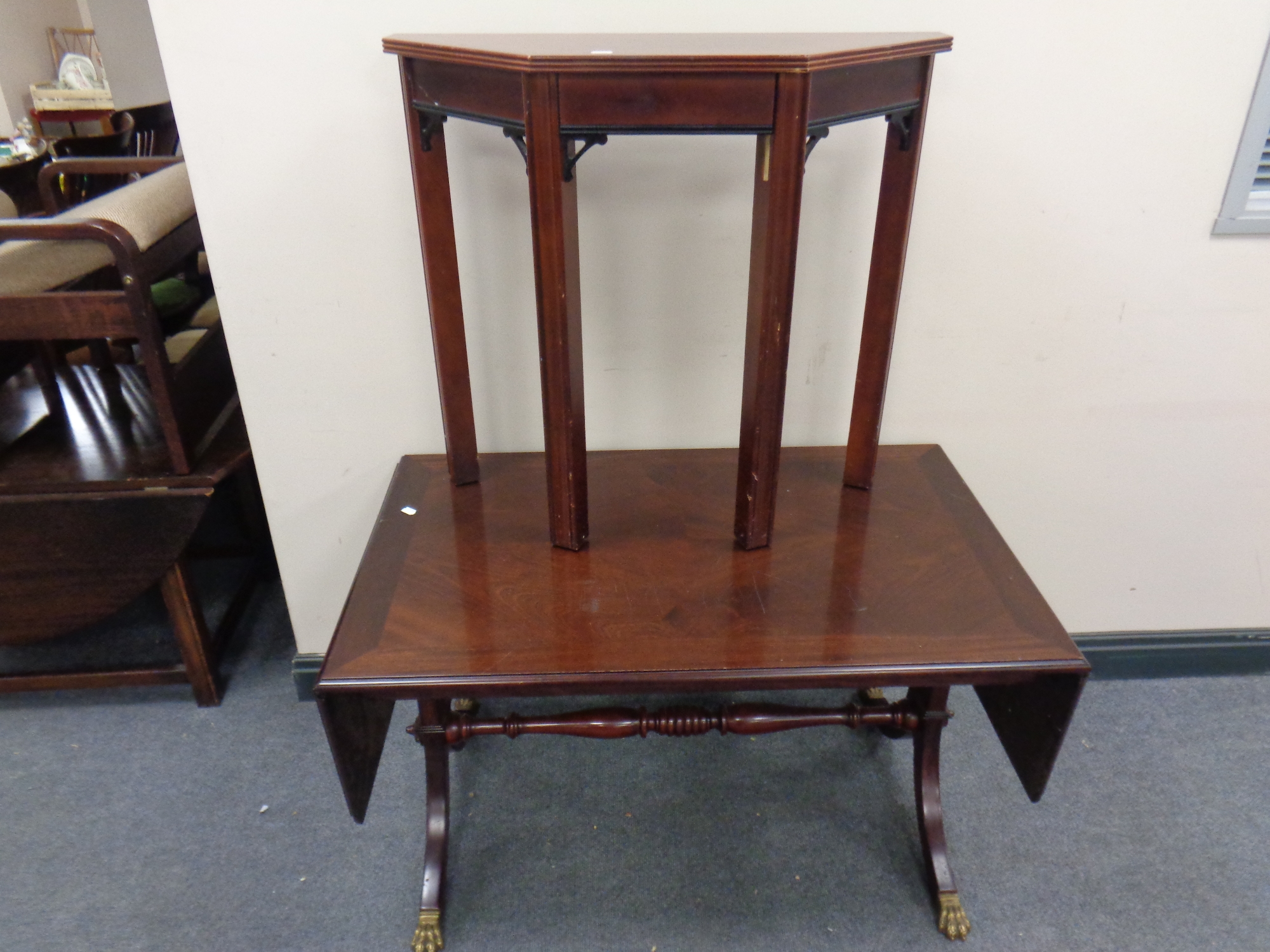 A mahogany flap sided sofa coffee table on brass capped feet together with a shaped hall table