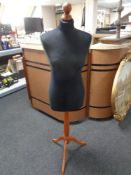 A dress maker's dummy on stand