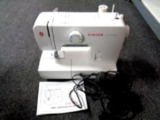 A Singer Promise electric sewing machine with foot pedal and manual