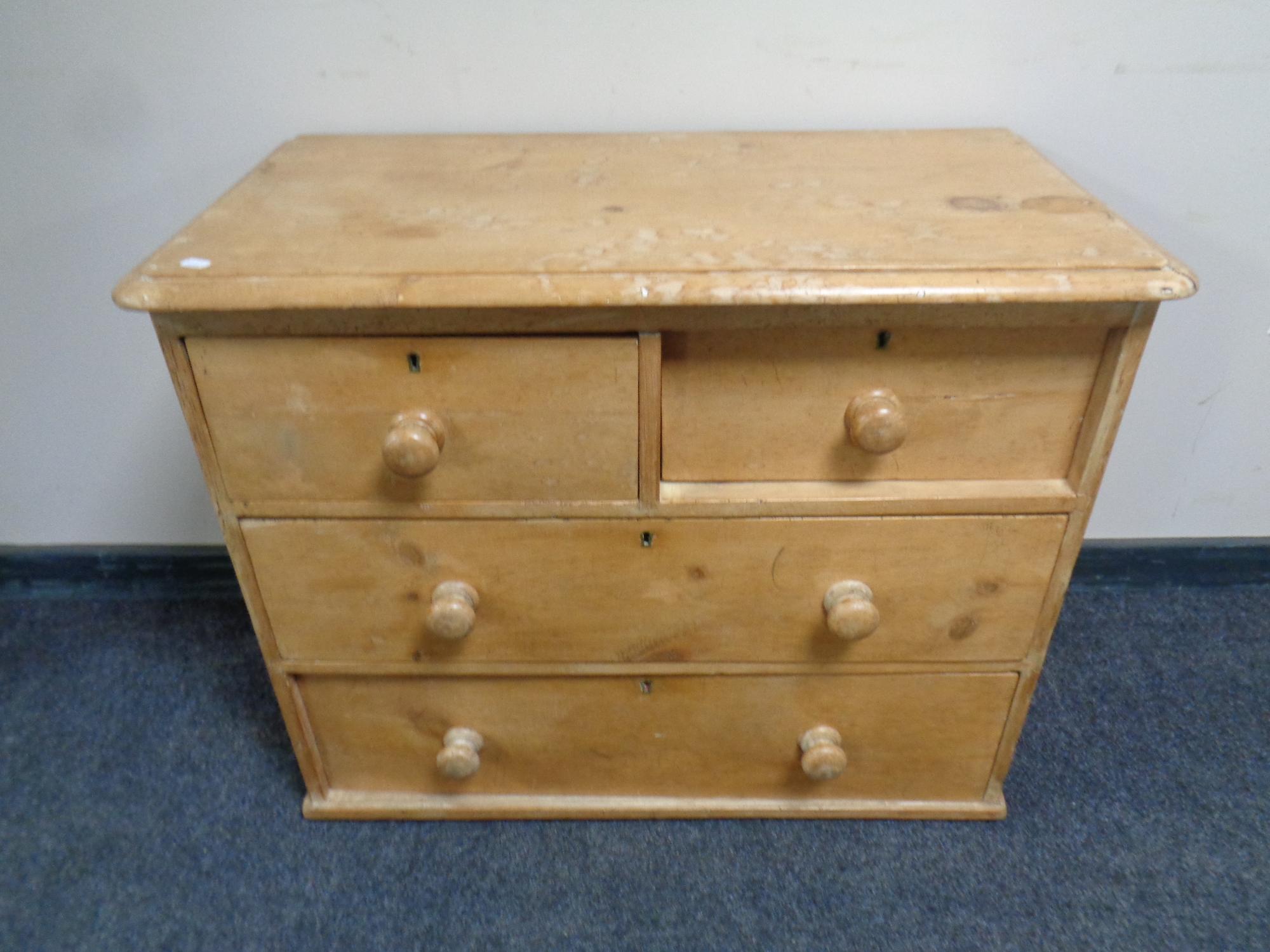 An antique pine four drawer chest