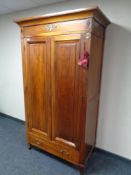 A reproduction Empire style double door wardrobe fitted drawer beneath