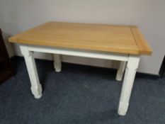 A contemporary oak topped dining table on painted pine base