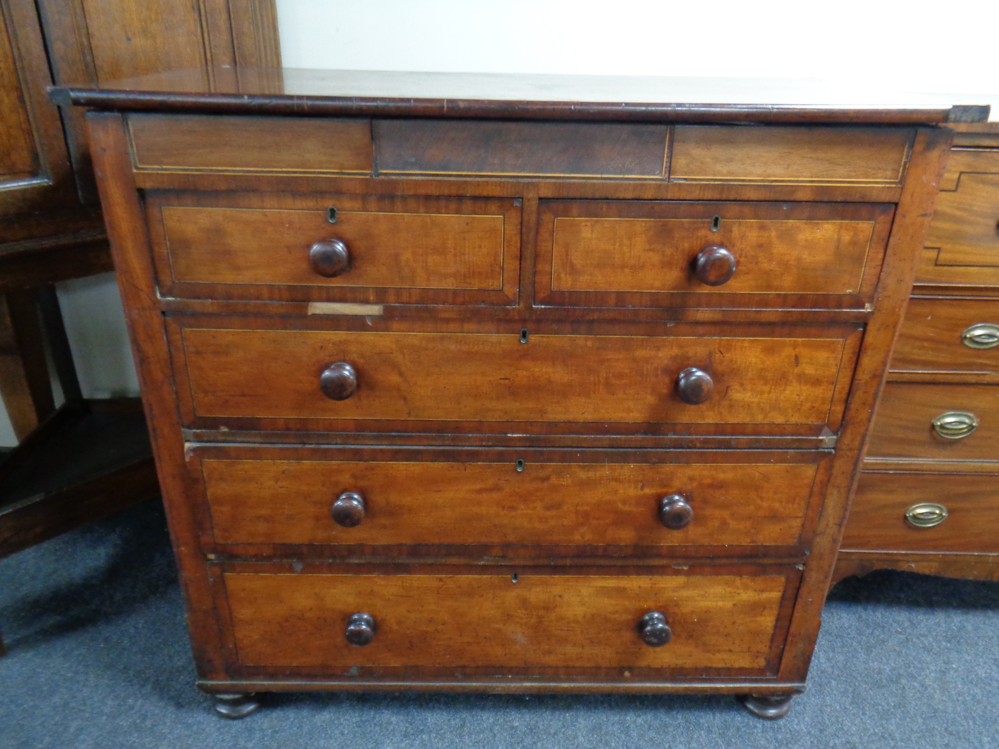 A Victorian mahogany chest of two over three drawers with secret drawer above