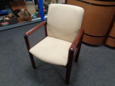 A 20th century Danish stained beech framed armchair upholstered in a striped fabric