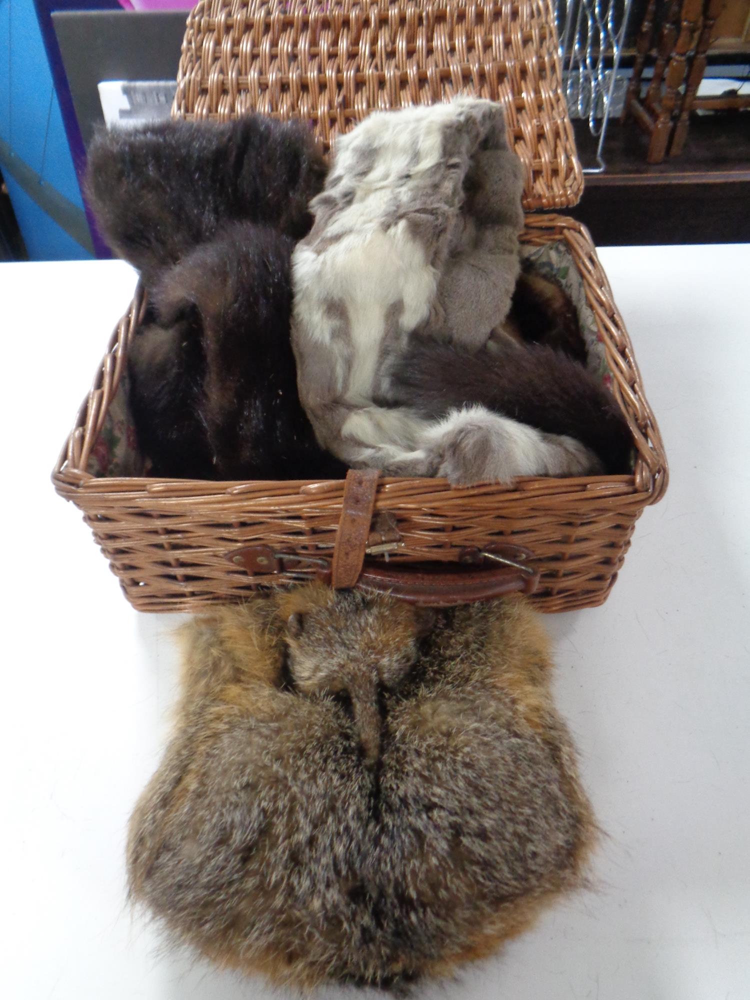 A wicker basket containing fox fur stoles