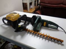 A JCB petrol hedge trimmer together with a Bosch electric chain saw,