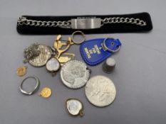 A bag of mixed items to include identity bracelet, King George medal, religious pendants,