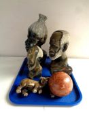 A tray containing three carved polished stone tribal busts together with two further animal figures,