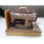 A cased 20th century Singer electric sewing machine