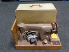 A 20th century Singer electric sewing machine in case and a Olivetti Lettra 32 typewriter in case
