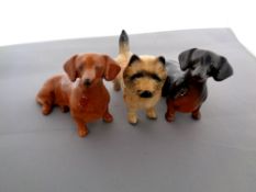 Three Beswick dog figures, seated Dachshund, black No. 1460, tan No.